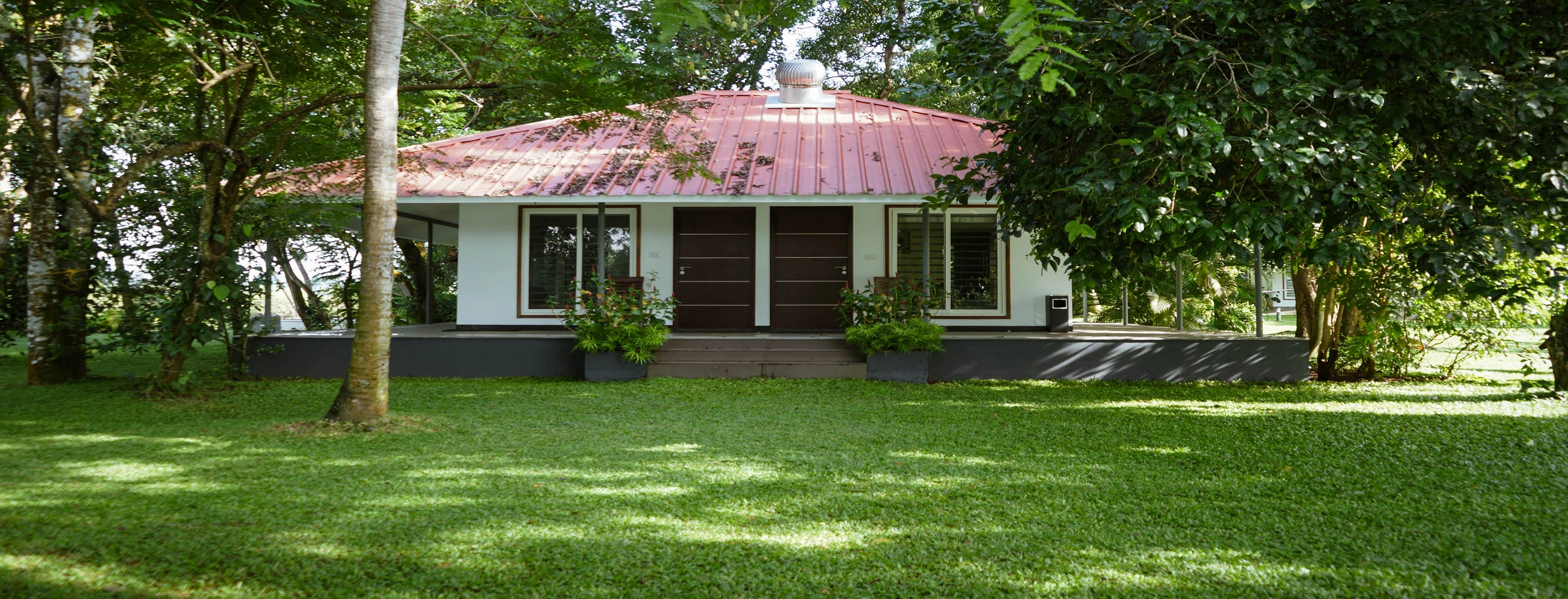 Giby Farm cottage surrounded by lush greenery